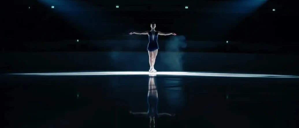 Video still from Kling 4.0 figure skating test: a skater gliding under a single spotlight on a dark ice rink