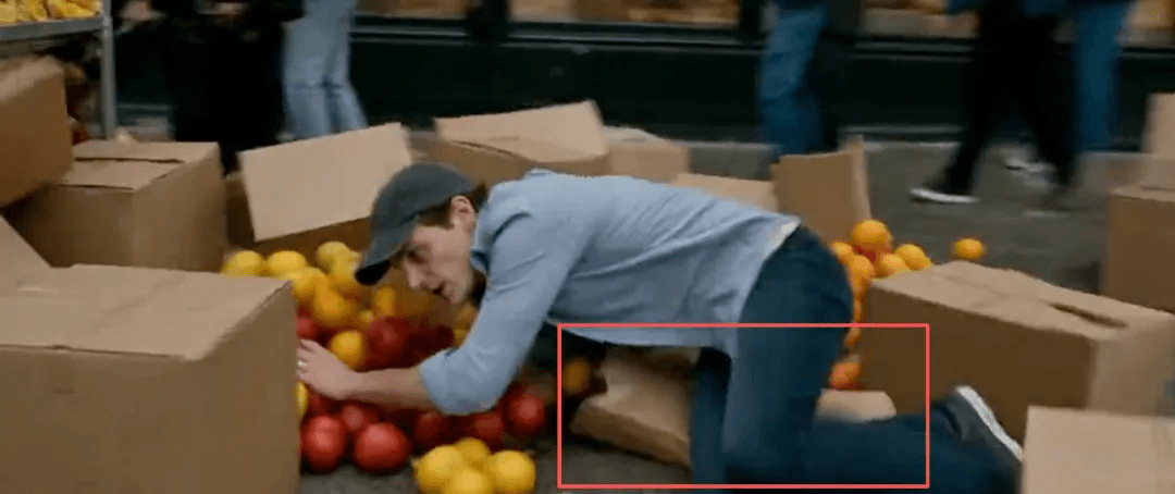 Close-up of Kling 4.0 physics detail: the runner lands on cardboard boxes that deform under him, highlighted with a red box